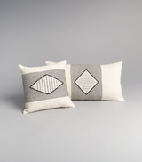Two decorative pillows featuring a diamond pattern in black and ivory.
