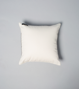 Top view of a plain ivory square pillow with a textured edge