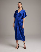 Model wearing a sapphire blue kaftan dress with a V-neck and relaxed fit.