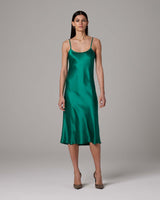 Emerald green midi slip dress on a model