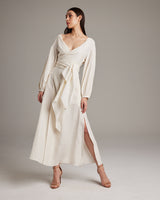 Model wearing a white Peasant Blouse Dress with a wrap silhouette and open neckline