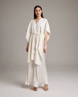 Model wearing a textured cotton solid kaftan over a slipdress
