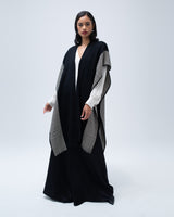 Model wearing a black and white striped edge caftan, styled with a black outfit.