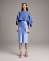 Model wearing a blue textured cotton crop top over a blue slip dress