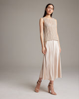 Model wearing a lace knit tank top with a skirt and heels