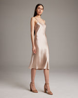 Blush Midi Slip Dress on model, showcasing its elegant drape and style.