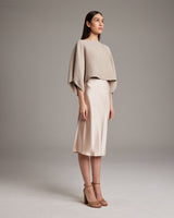 Model wearing a textured cotton crop top with a satin skirt and heels