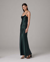Model wearing a green liquid silk slipdress, showcasing its elegant fit and design.