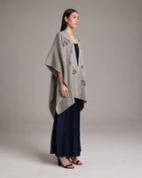 Model wearing a grey Copihue Duster with geometric patterns over a navy dress