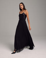 Model wearing a black Crinkle Chiffon Double Layer Skirt, showcasing its flow and design.