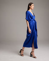 Model wearing a sapphire blue kaftan dress with a belt