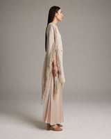 Model wearing a pearl fringe kaftan with a cropped silhouette and expansive sleeves
