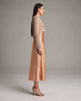 Model wearing a Painted Loose Knit Cropped Sweater in sand color, side view