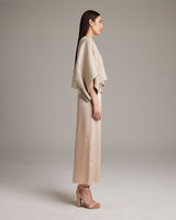 Model wearing a pearl crop top with a textured surface, side view