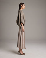Model wearing a shimmering cotton bolero in pewter color, side view