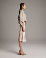Side view of a model wearing a textured cotton crop top with a satin skirt