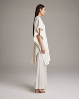 Model wearing a textured cotton solid kaftan, side view