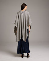 Model wearing a grey Copihue Duster, back view, paired with a navy dress.