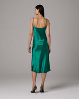Back view of green satin midi slip dress with thin straps