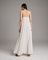 Back view of a flowy ivory Parachute Slip Dress with thin straps