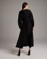 Back view of a black Peasant Blouse Dress with a wrap silhouette