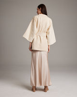 Model wearing an ivory Samurai Jacket with wide sleeves and a detachable belt, viewed from the back.