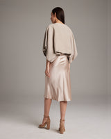 Model wearing a textured cotton crop top over a satin dress, viewed from the back.