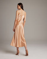 Model wearing a peach V-neck slip dress from the back