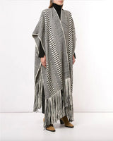 Model wearing a black and white long chevron duster with fringe