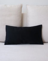 Black Condor Lumbar Pillow on a light-colored couch
