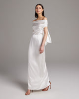 Model wearing a bridal convertible halter dress in ivory, showcasing its elegant design and silk fabric.