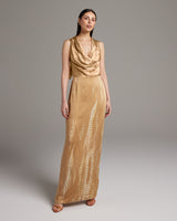 Model wearing a gold tie dye convertible dress, showcasing its elegant design.