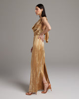 Side view of a gold tie dye convertible dress with a dramatic wrap sash