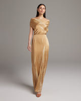 Model wearing a gold tie dye convertible dress with off-shoulder design