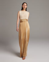 Model wearing a gold tie-dye convertible dress with a wrap sash