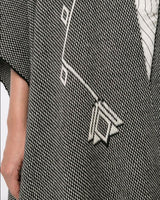 Close-up of Copihue Duster fabric showing geometric pattern in black and white