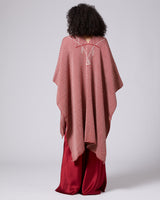 Back view of a red Copihue Duster with geometric design, worn over a red outfit