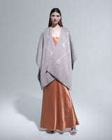 Model wearing a gray Copihue Duster over an orange dress