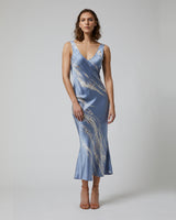 Model wearing a blue tie dye double V slipdress made of silk charmeuse