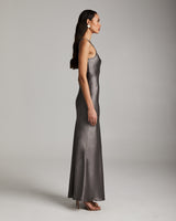 Model wearing a long double V slip dress in silver mink, side view