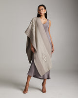 Model wearing the Estrella Shawl in grey, showcasing its design and texture.