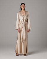 Model wearing a silk Featherlight Wrap Blouse in a light color, tied at the waist.