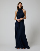 Model wearing a navy Matte Chiffon Palazzo Jumpsuit, standing with hands clasped, showcasing the design.