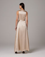 Back view of a model wearing a beige Frontward Wrap Dress