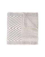 Hand-loomed baby alpaca scarf featuring a chevron pattern in grey and white.