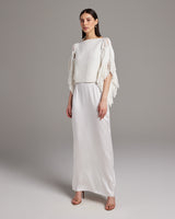 Model wearing a Lace Fringe Crop Top with a long white skirt