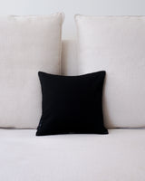 Black Centro Lineas Square Small Pillow on a light-colored couch