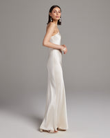 Model wearing a bridal liquid slipdress in ivory, showcasing its elegant silhouette.