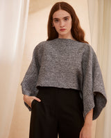 Model wearing a gray Marble Crop Top with wide sleeves and black pants