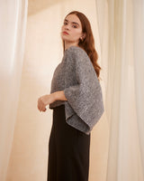 Model wearing a gray Marble Crop Top with wide sleeves, standing against a soft backdrop.